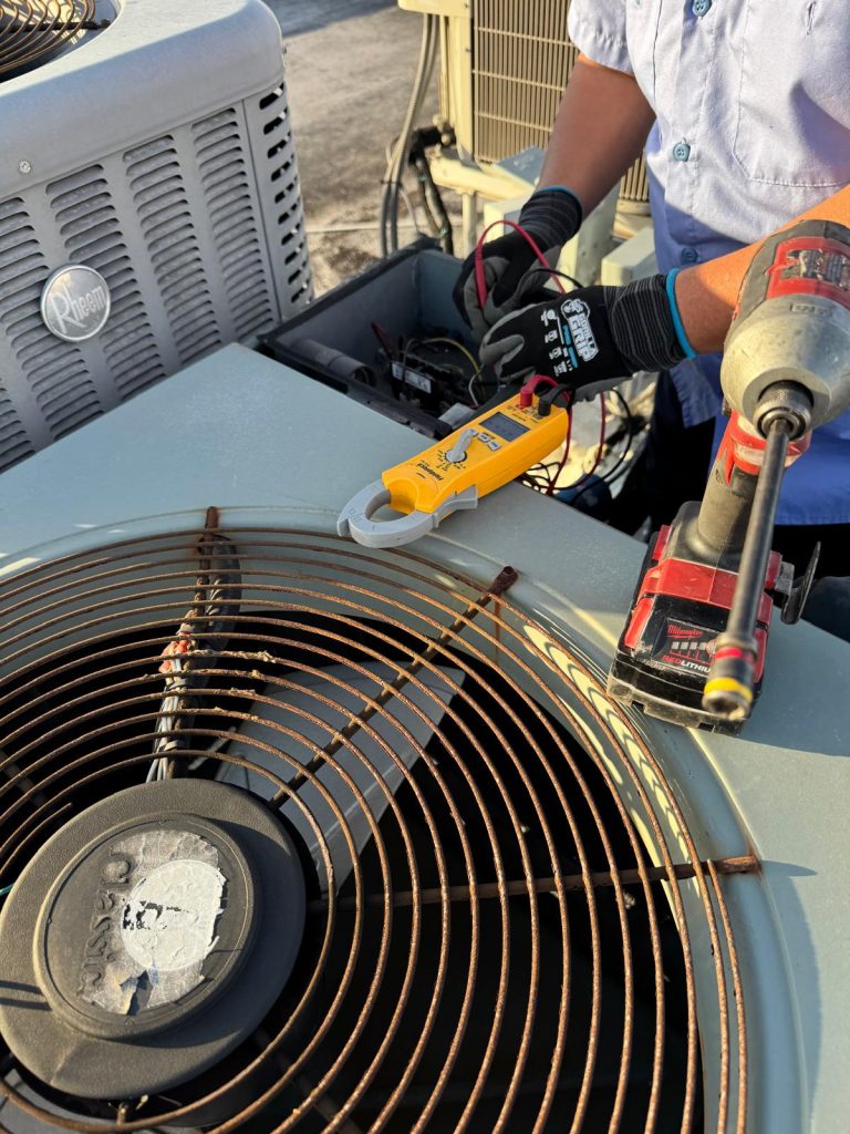 Emergency AC Repair in Sunrise FL technician repairing outdoor AC unit