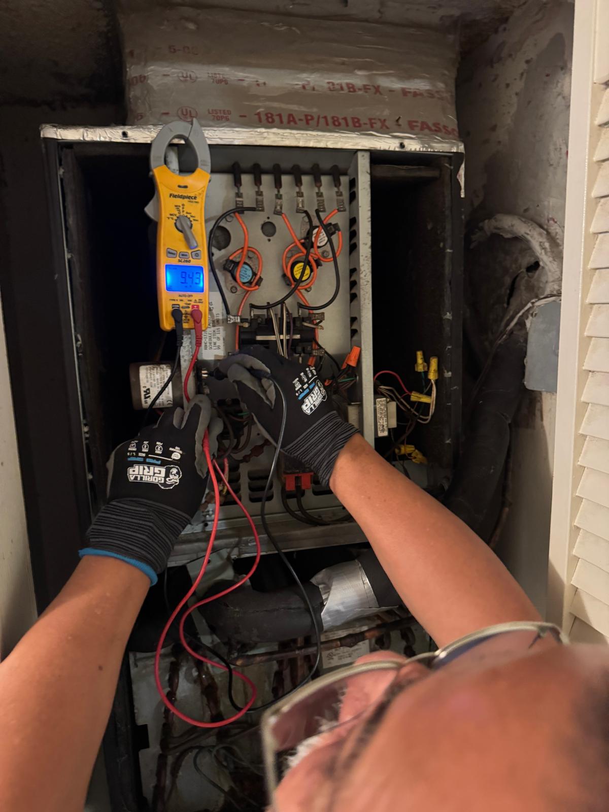 HVAC services in Broward County technician checking electrical connections